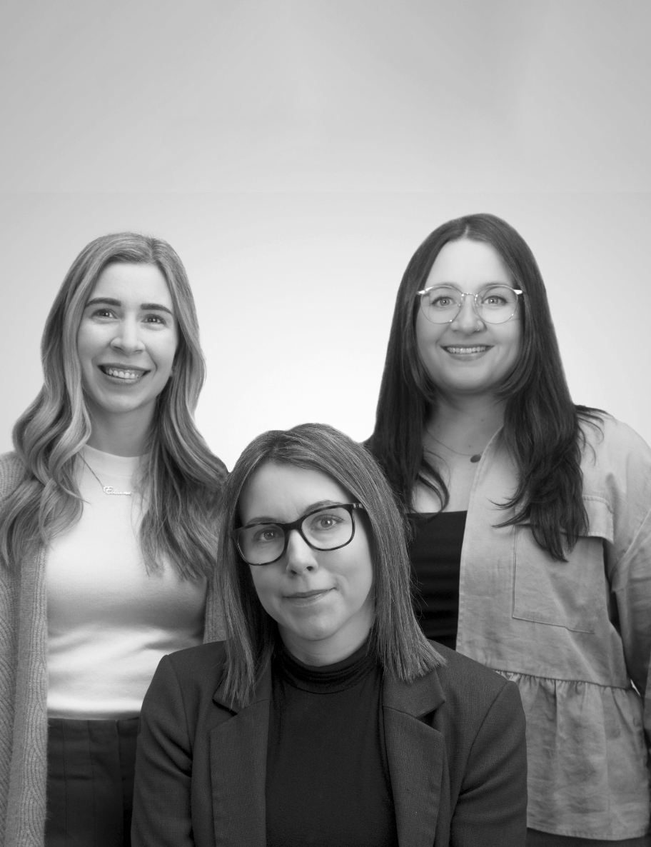 Leadership team Mandy, Kristy and Courtney smiling on a plain background.